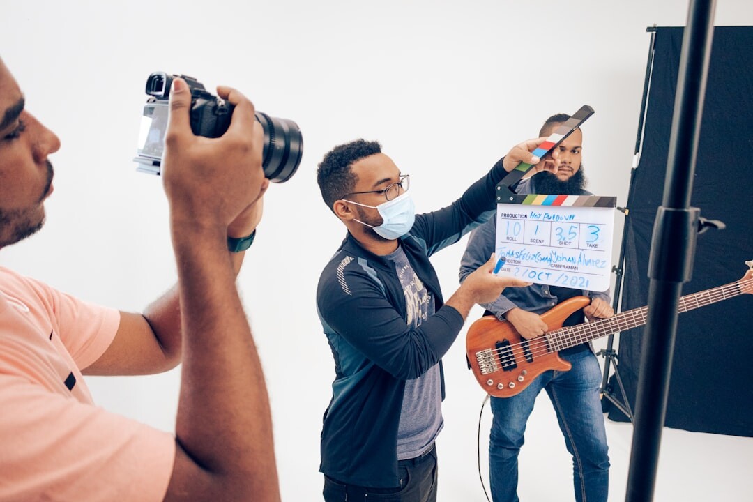 Small creative team reviewing footage together around a laptop